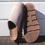 Vista Luxe Mariana clogs in beige suede, left shoe facing right showing closed toe, right shoe sole up with REEF logo visible
