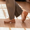 Vista Luxe Solene platform clogs facing left and right, showing side and sole views with adjustable straps and arch support.
