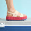 Side view of Water Vista Higher sandal for women with pink platform sole and beige straps, highlighting comfort and arch support.