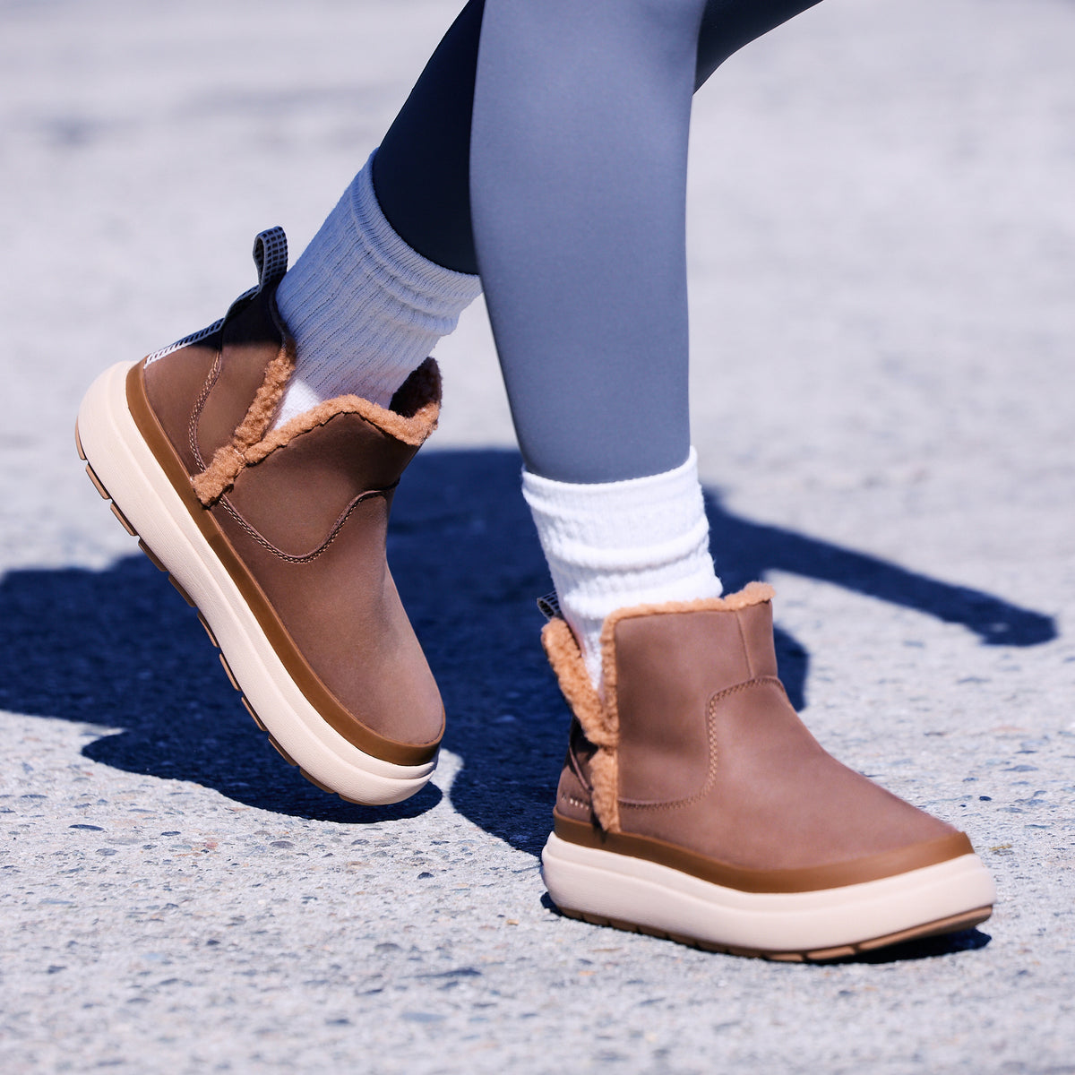 Weekend Autumn brown cozy boots, one facing right and one facing left, with shearling lining and cushioned soles