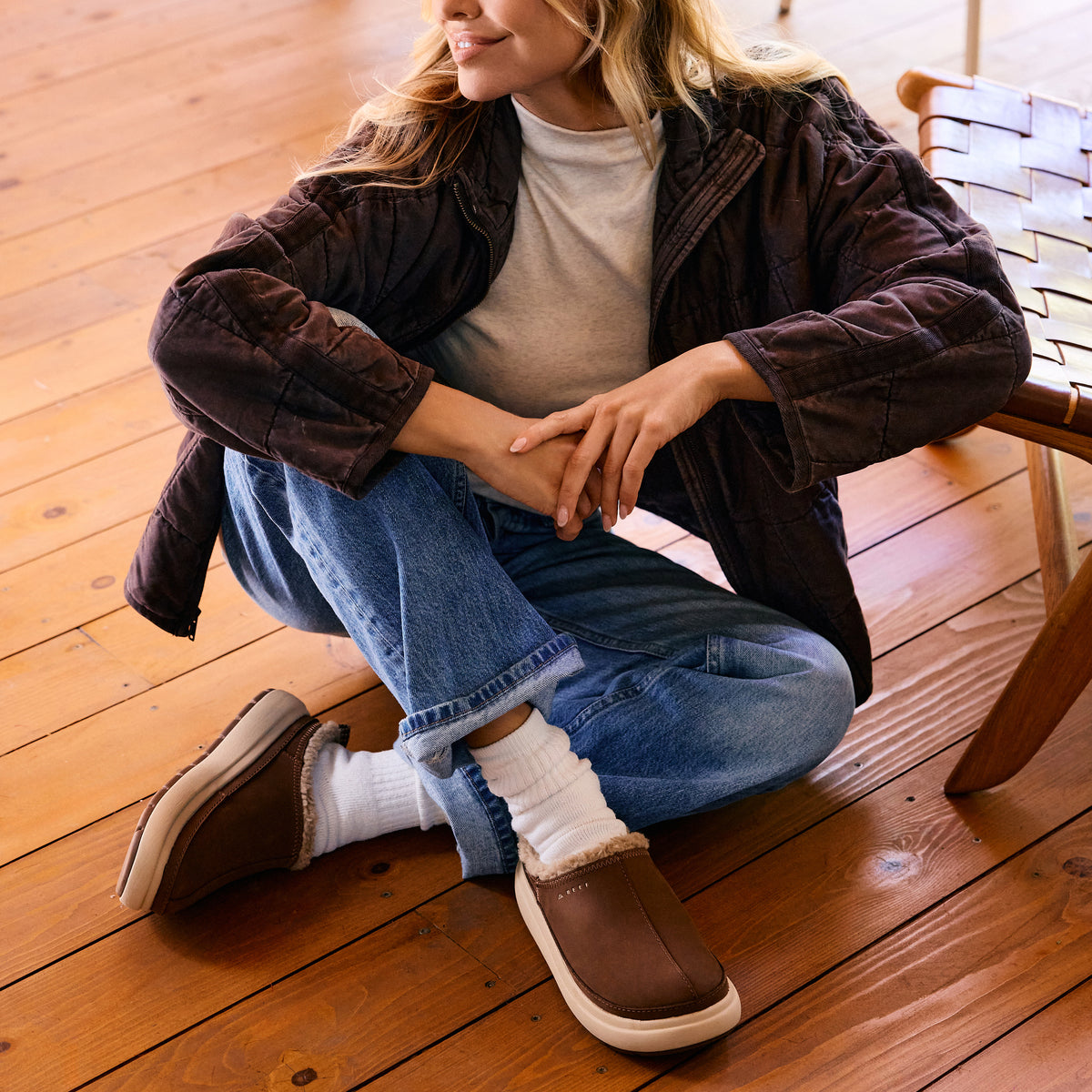 Weekend Low Brooke brown shoes angled toward the camera on a seated woman, showcasing comfortable easy on and off style