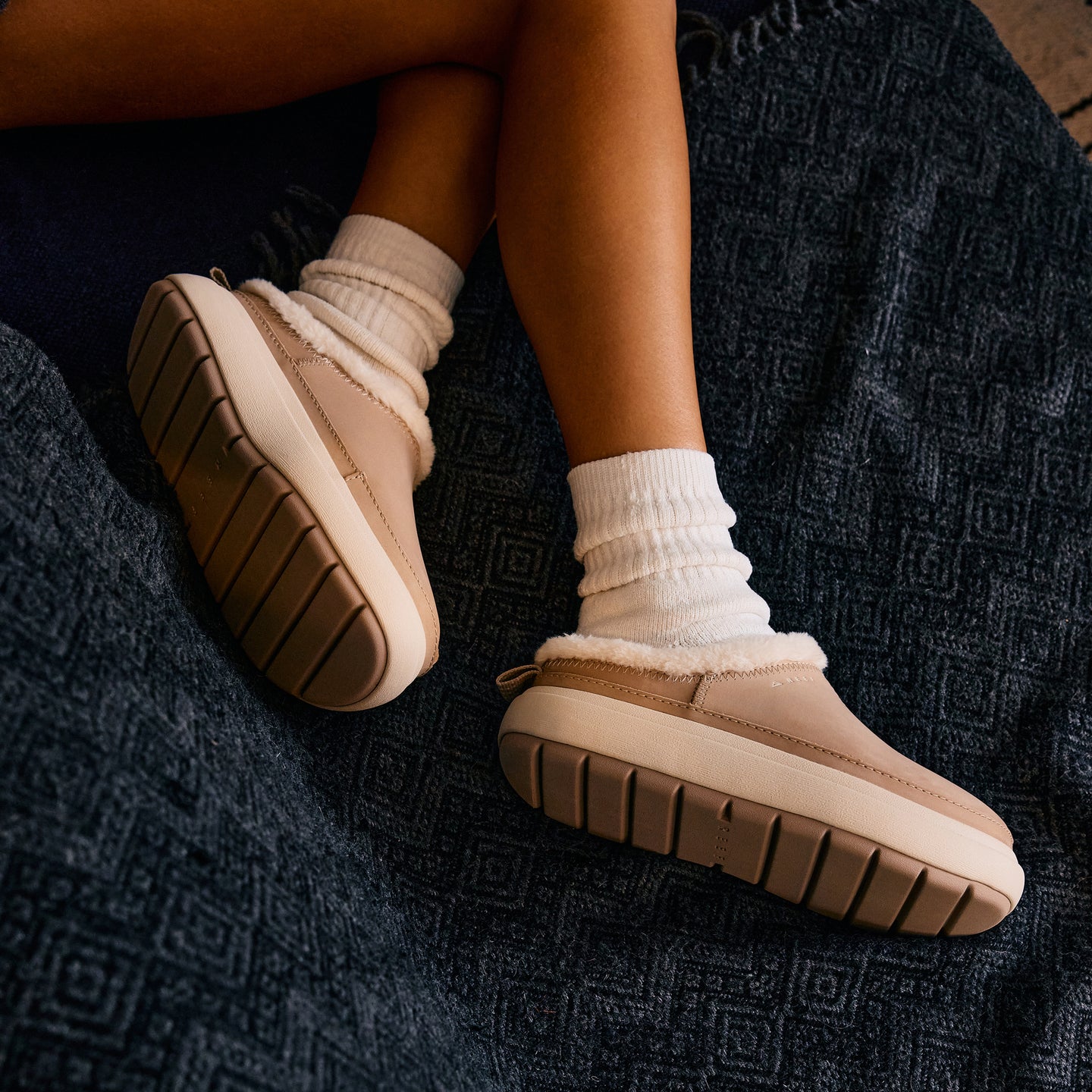 Weekend Low Brooke leather shoes with toes facing right, cushioned soles, and cozy sock cuffs on feet