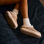 Weekend Low Brooke leather shoes with toes facing right, cushioned soles, and cozy sock cuffs on feet