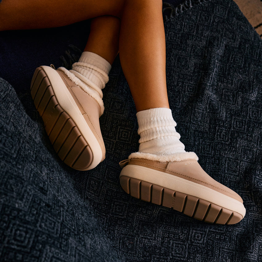 Weekend Low Brooke leather shoes with toes facing right, cushioned soles, and cozy sock cuffs on feet