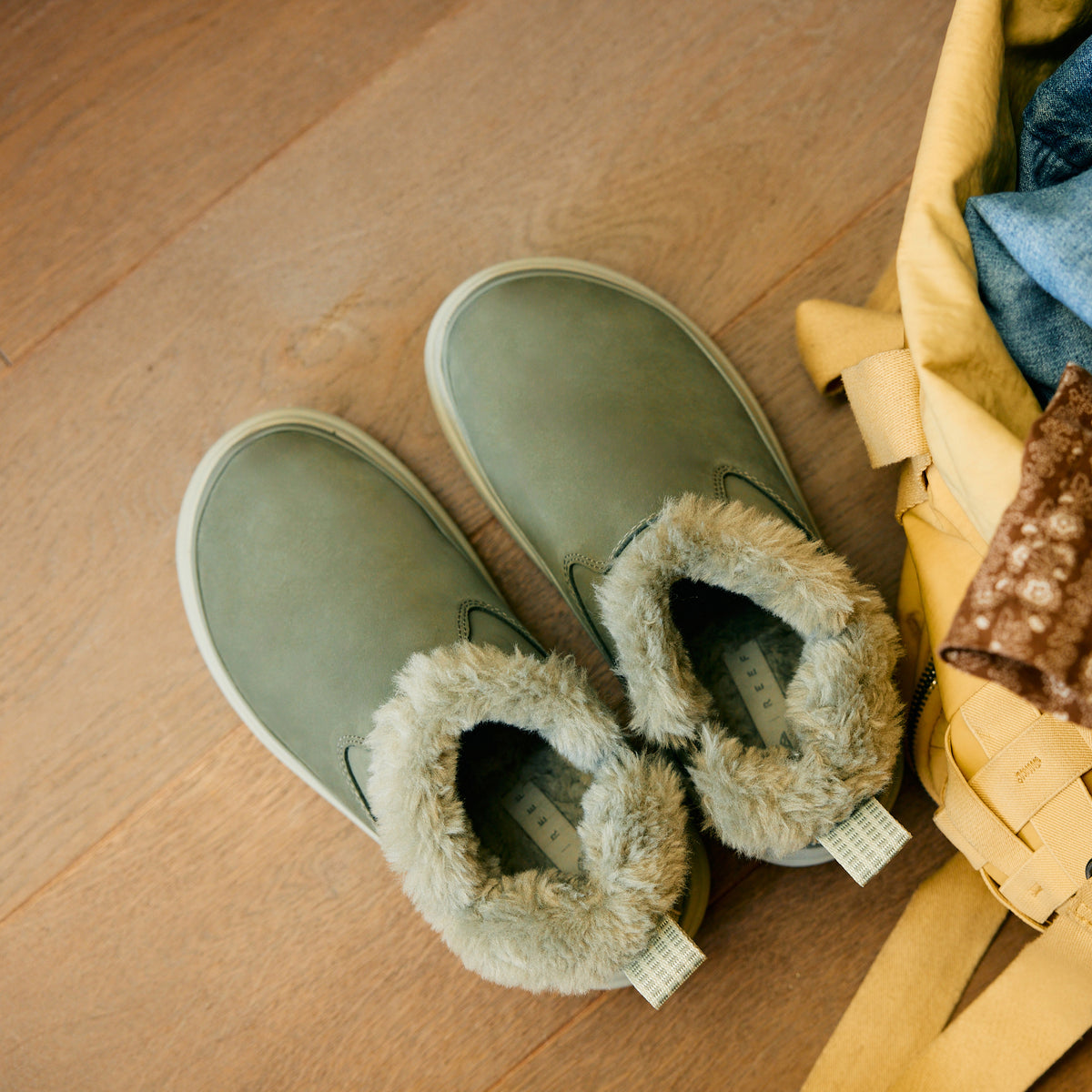 Weekend Olivia green nubuck shoes with plush faux fur lining, toes facing upper left in a top view close-up