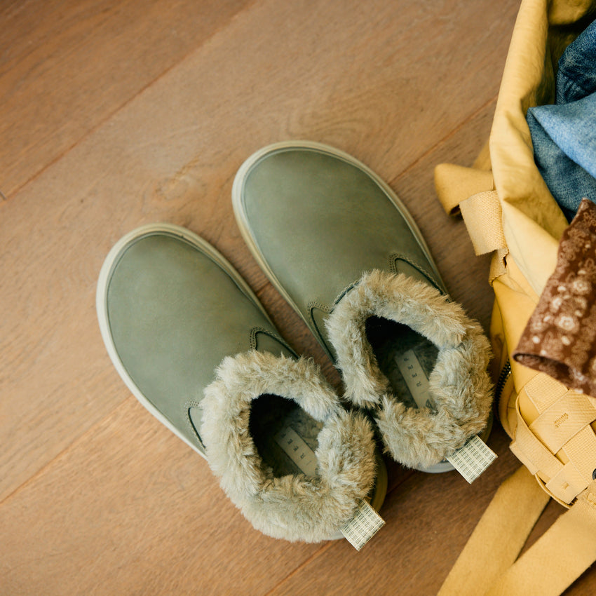 Weekend Olivia green nubuck shoes with plush faux fur lining, toes facing upper left in a top view close-up
