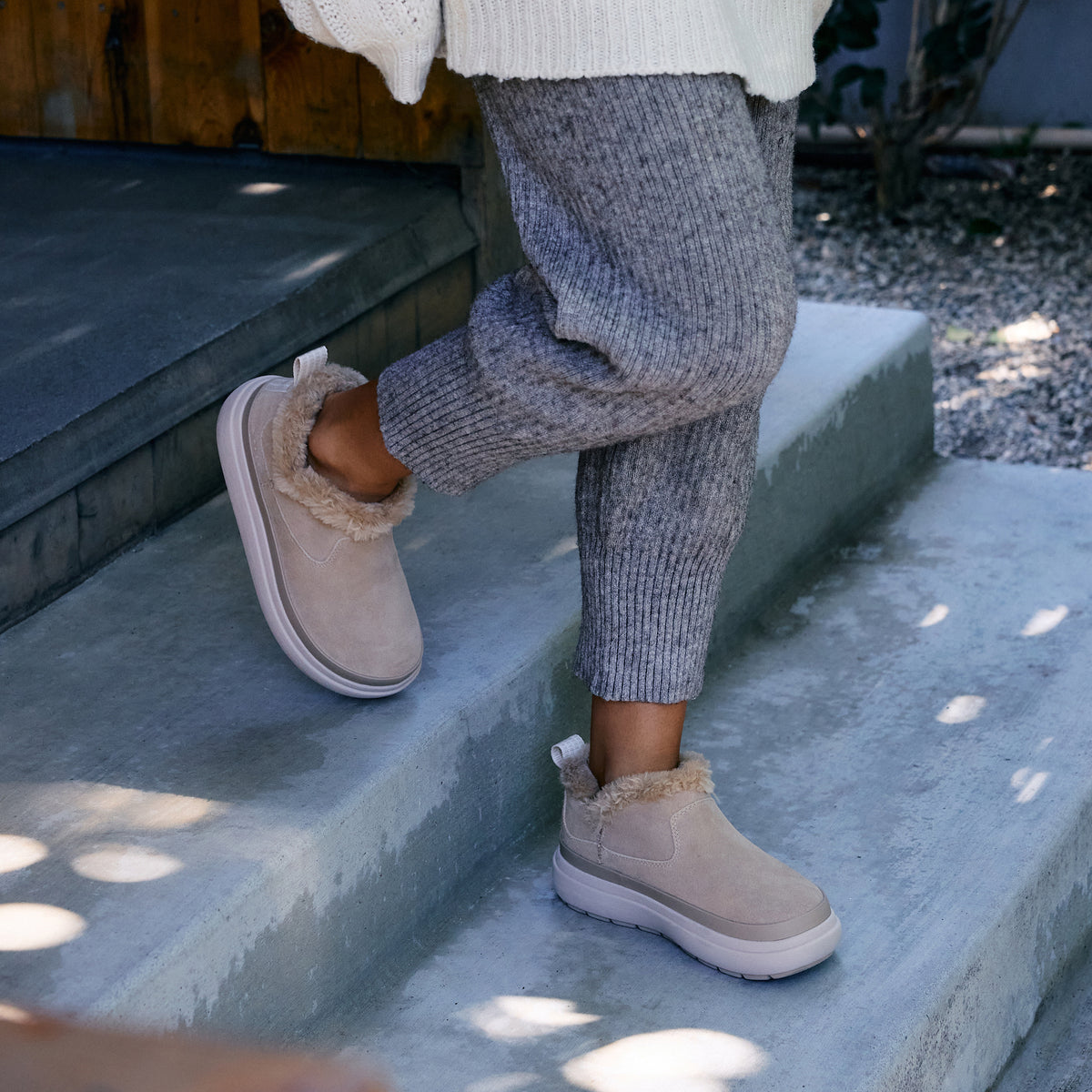 Weekend Olivia water-resistant nubuck shoes with faux fur lining, facing opposite directions on concrete steps