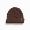 Alyx Beanie in brown knit fabric, close-up front view showing soft texture, designed for comfort and beach lifestyle.