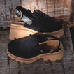 Vista Luxe Solene in black suede, side view showing adjustable buckle straps and cushioned platform sole, women's leather clogs.