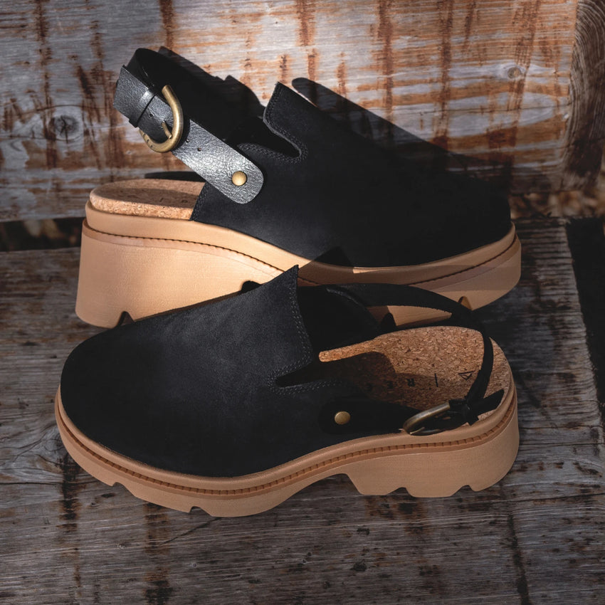 Vista Luxe Solene in black suede, side view showing adjustable buckle straps and cushioned platform sole, women's leather clogs.