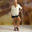 Cali Laguna women's black platform sandal facing forward worn with casual shorts and shirt against palm backdrop