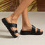 Pair of black Cali Solana sandals facing left showing side and top views with cushioned platform soles for beach comfort.