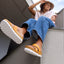 woman sitting on ledge in reef platform sandals